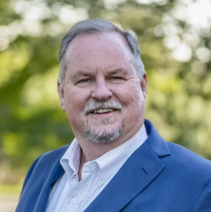 Lee Allen Miller in a blue blazer, outdoors